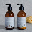 Dog Walkers Revival Hand Wash and Hand Lotion side by side in amber glass bottles — vitamin E hand care duo, dog walker gift by Sweet William Designs
