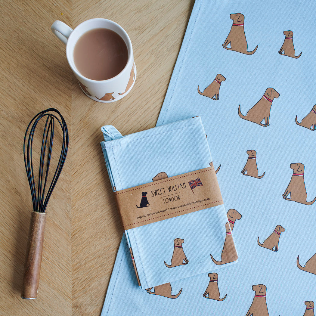 Organic cotton Fox Red Labrador tea towel on a wooden table with a matching mug — organic cotton screen printed kitchen gifts for dog lovers by Sweet William Designs