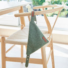 Smart green tweed dog bandana threaded onto its matching collar, ready for country walks and Sunday afternoons at the pub