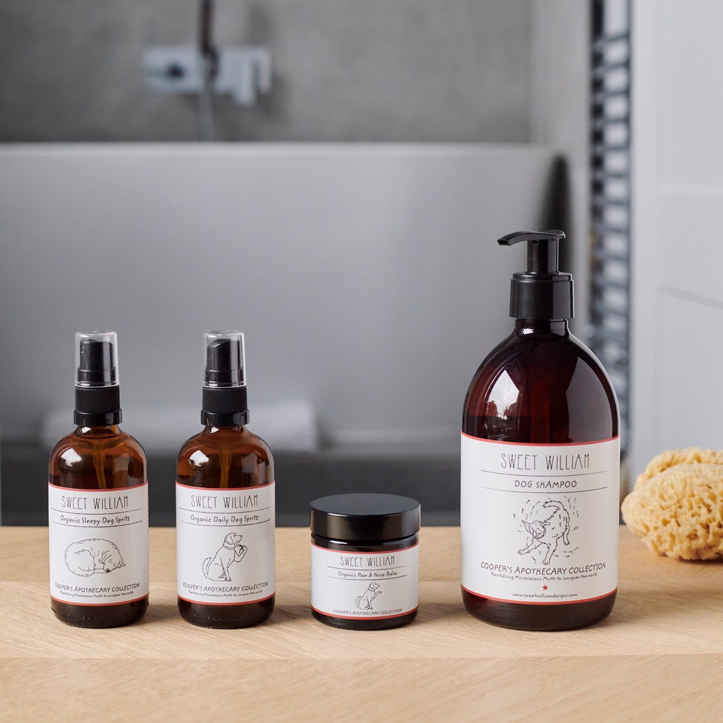 Sweet William Cooper’s Apothecary grooming collection with Organic Sleepy Dog Spritz, Organic Daily Dog Spritz, paw balm and dog shampoo
