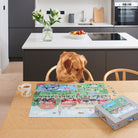 Cooper the Golden retriever sitting at kitchen table inspecting the Dog Walkers of London jigsaw puzzle — 1000 piece dog lover gift by Sweet William Designs