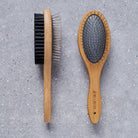 Bamboo double sided dog brush on grey stone surface — dog grooming brush by Sweet William Designs