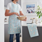 Organic cotton Apricot Cockapoo / Labradoodle tea towel with a matching apron, styled as a coordinated kitchen set —  kitchen gift for dog lovers by Sweet William Designs.