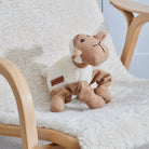 Woolliam the Lamb dog toy on a fluffy chair — soft fabric squeaky toy by Sweet William Designs