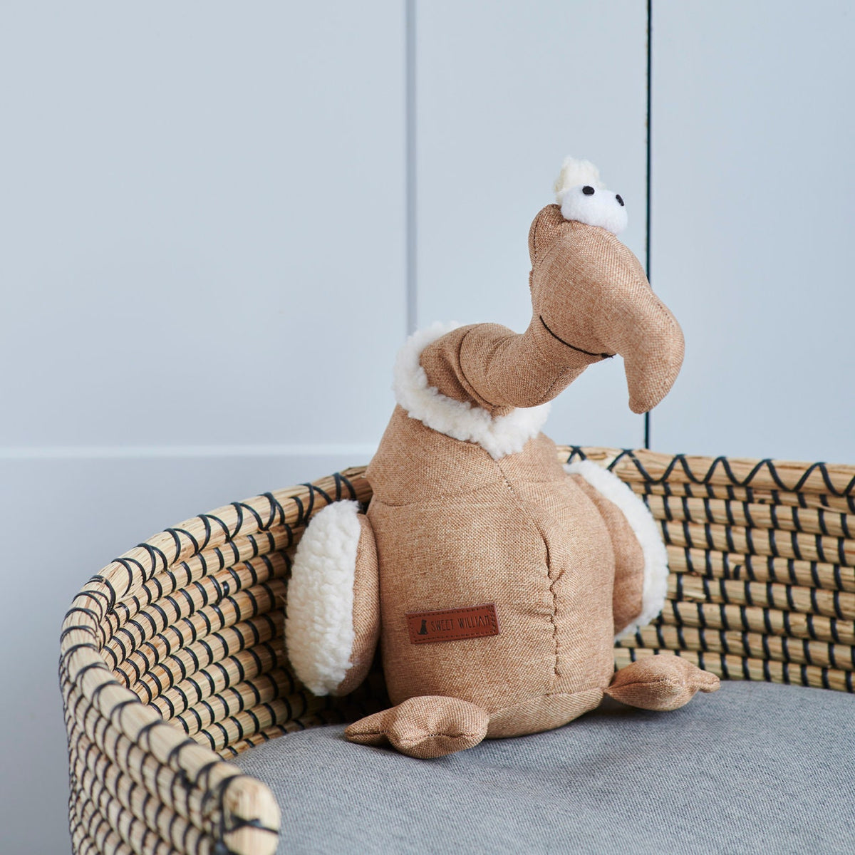 Close-up of Tarquin the Dodo dog toy in a wicker basket — soft fleece and fabric plush toy by Sweet William Designs
