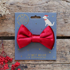 A rich red velvet dog bow tie displayed on its Sweet William Christmas backing card, a thoughtful gift for a much-loved dog