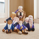 Golden Retriever surrounded by full range of political parody dog toys including King Charles, Trump, Boris and more — funny dog lover gifts