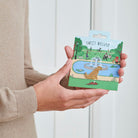 Golden Retriever enamel dog pin held in hands on illustrated park backing card — gold-plated dog lover gift by Sweet William Designs