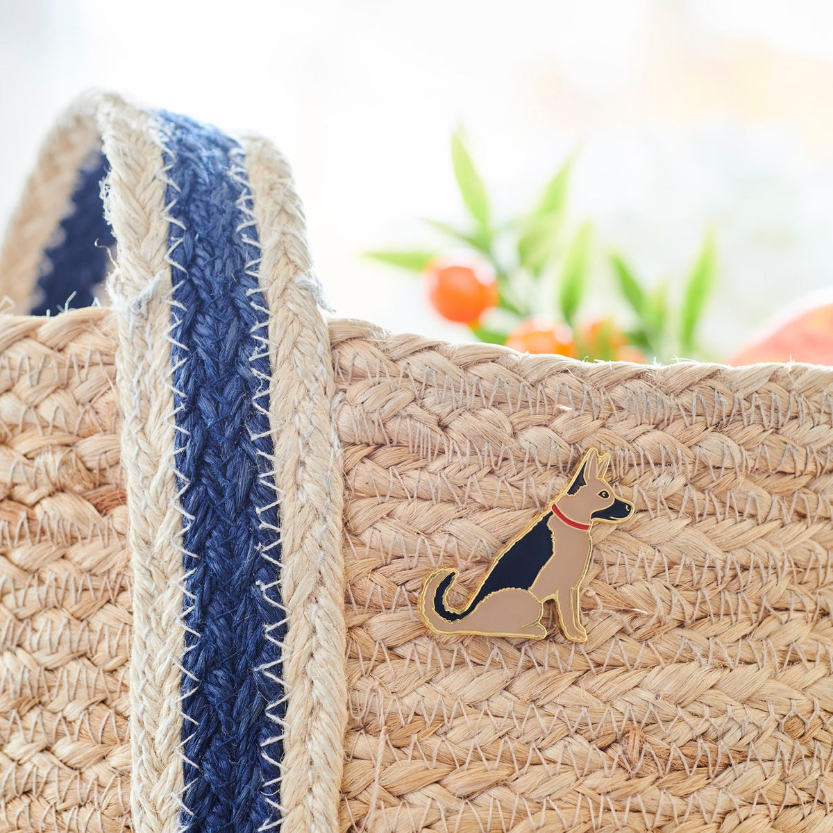 Close up of German Shepherd enamel pin styled on a jute bag — gold-plated dog pin, perfect gift for dog lovers
