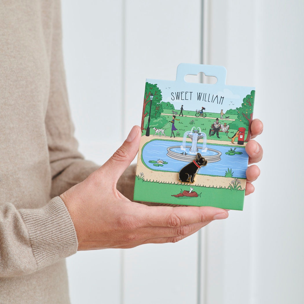 French Bulldog enamel dog pin held in hands on illustrated park backing card — gold-plated dog lover gift by Sweet William Designs