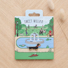 Dachshund enamel dog pin on Sweet William Designs park scene backing card — thoughtful gift for Dachshund lovers
