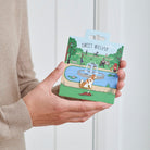 Cavalier King Charles Spaniel enamel dog pin held in hands on illustrated park backing card — gold-plated dog lover gift by Sweet William Designs