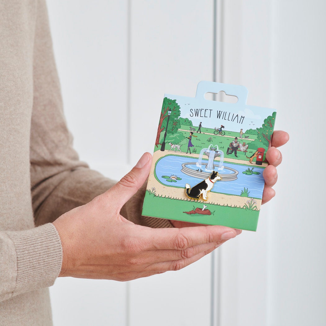 Border Collie enamel dog pin held in hands on illustrated park backing card — gold-plated dog lover gift by Sweet William Designs