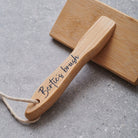 Close-up of personalised bamboo slicker brush handle personalised with name of dog — dog grooming gift by Sweet William Designs