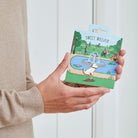 Westie enamel dog pin held in hands on illustrated park backing card — gold-plated dog lover gift by Sweet William Designs