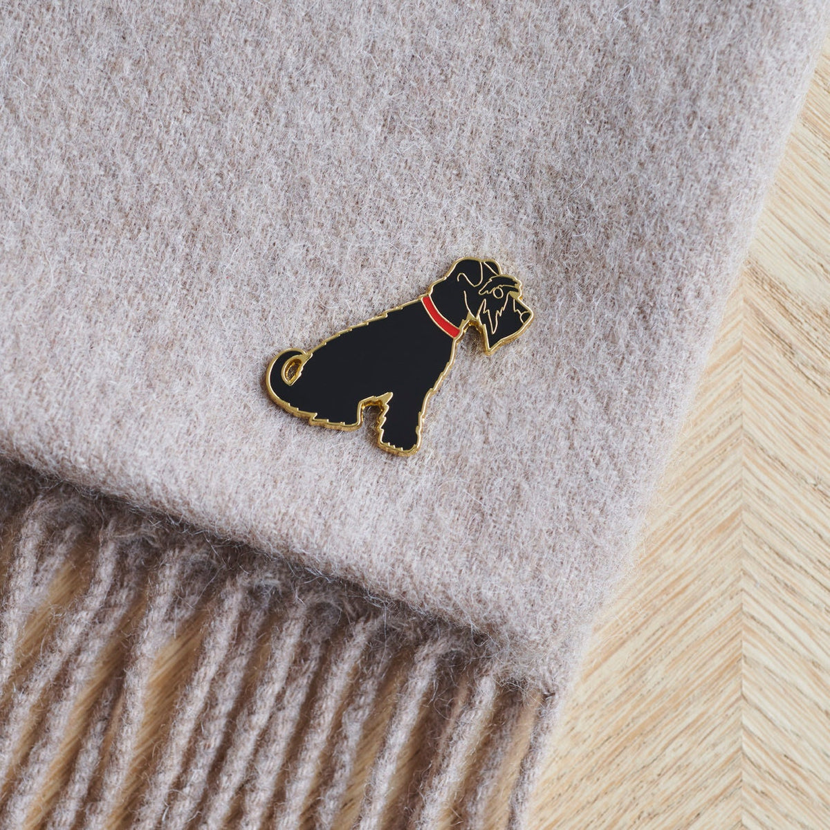 Black Schnauzer enamel pin styled on a wool scarf — gold-plated dog pin, perfect gift for dog lovers