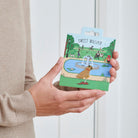 Pug enamel dog pin held in hands on illustrated park backing card — gold-plated dog lover gift by Sweet William Designs