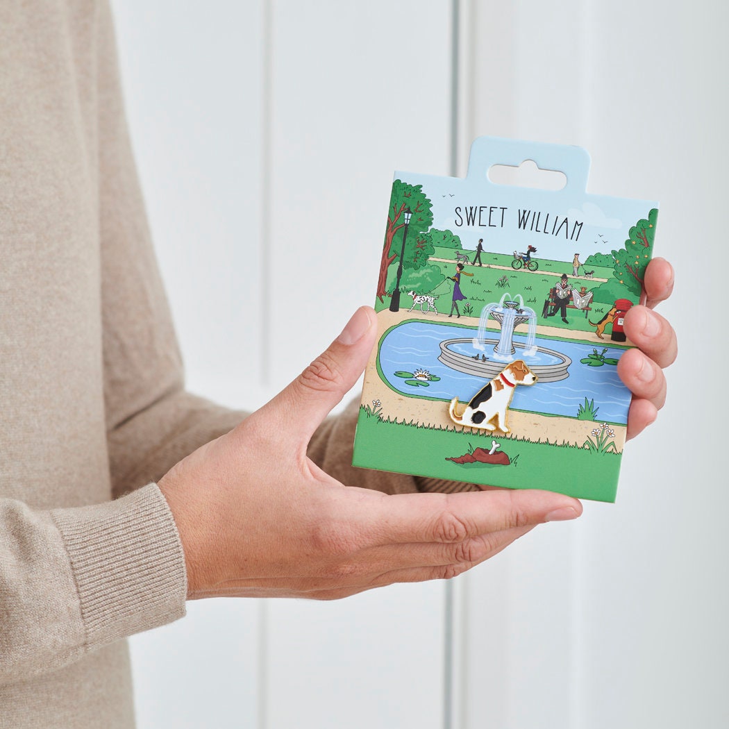 Jack Russell enamel dog pin held in hands on illustrated park backing card — gold-plated dog lover gift by Sweet William Designs