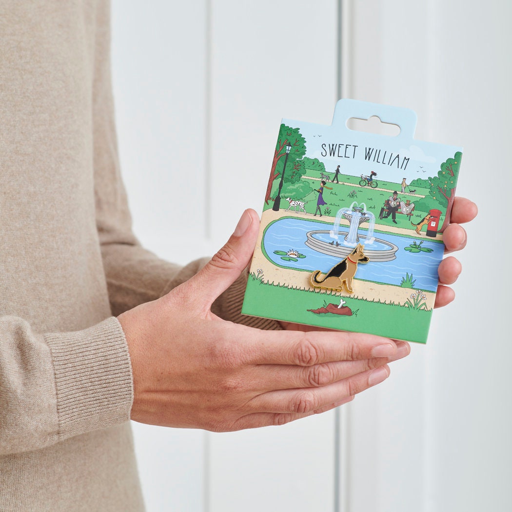 German Shepherd enamel dog pin held in hands on illustrated park backing card — gold-plated dog lover gift by Sweet William Designs