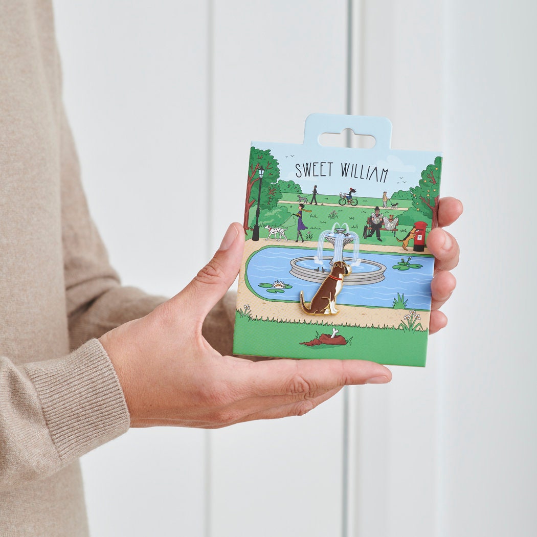 Boxer enamel dog pin held in hands on illustrated park backing card — gold-plated dog lover gift by Sweet William Designs