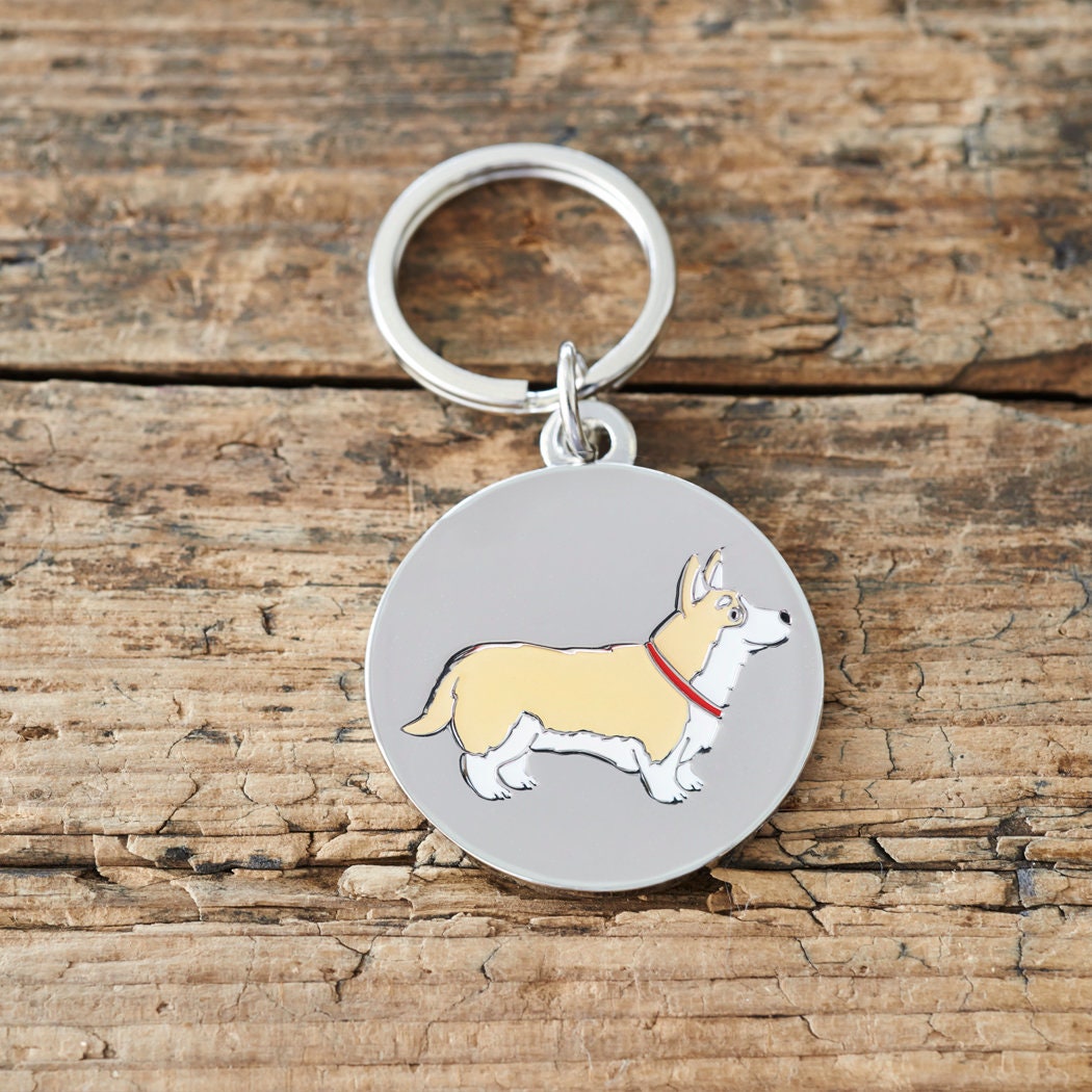 Close-up of Corgi personalised dog tag — silver-plated brass with illustrated Corgi design, personalised dog lover gift by Sweet William Designs