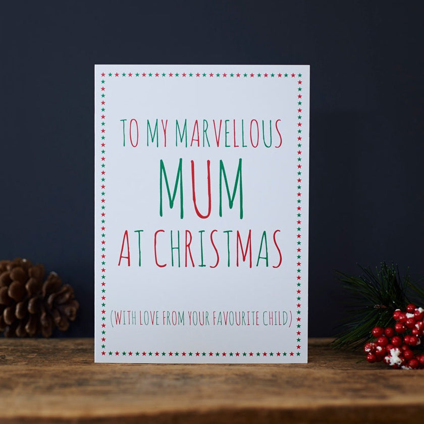 Funny Christmas card for Mum reading “To My Marvellous Mum at Christmas” and “With love from your favourite child”, with red and green lettering, a star border, pine cone and red berries.