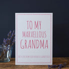 Cheeky card for Grandma reading “To My Marvellous Grandma” and “With love from your favourite grandchild”, displayed beside flowers