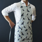 Grey Schnauzer apron in organic cotton canvas with screen-printed repeat Schnauzer illustration — a perfect gift for Schnauzer lovers by Sweet William Designs