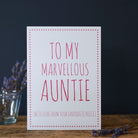 White Auntie card with pink lettering reading “To My Marvellous Auntie” and “With love from your favourite niece”, a pink star border and dried flowers beside it.