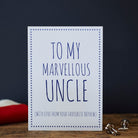 White Uncle card with blue lettering reading “To My Marvellous Uncle” and “With love from your favourite nephew”, a blue star border and silver cufflinks beside it.