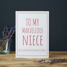 White Niece card with pink lettering reading “To My Marvellous Niece” and “With love from your favourite Auntie”, a pink star border and dried flowers beside it.