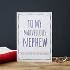 White Nephew card with blue lettering reading “To My Marvellous Nephew” and “With love from your favourite Uncle”, a blue star border and silver cufflinks beside it.