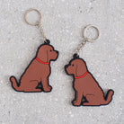 Chocolate Cockapoo / Labradoodle keyring showing both sides — double-sided PVC design with Sweet William's classic illustration